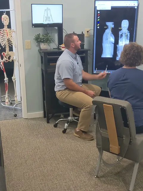 Dr. Tokar reviewing a patient's diagnostic evaluation at Cross Chiropractic